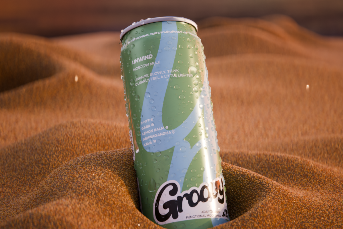 What is GABA? Groovy Unwind Moscow Mule functional mocktail can resting on sand.